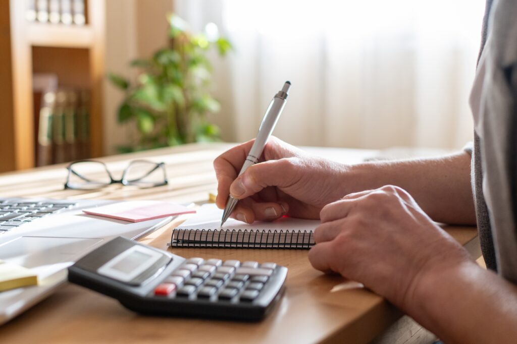 Businessman writing and learning about revenue-based financing.